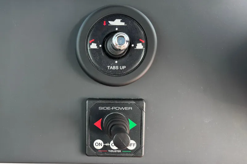 Slide: The Image of Control panel of 2022 Axopar 28 Cabin boat with trim tabs and side-power thruster. - 28