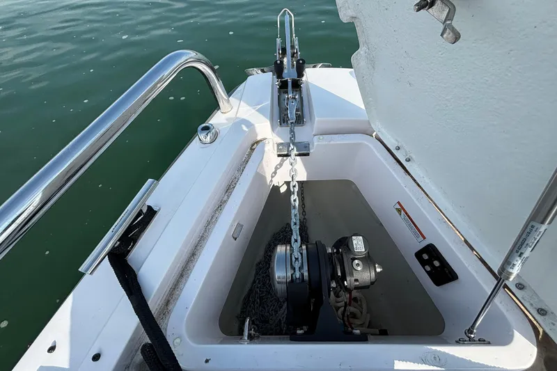 Slide: The Image of Anchor compartment of 2022 Axopar 28 Cabin boat with chain and winch system. - 33