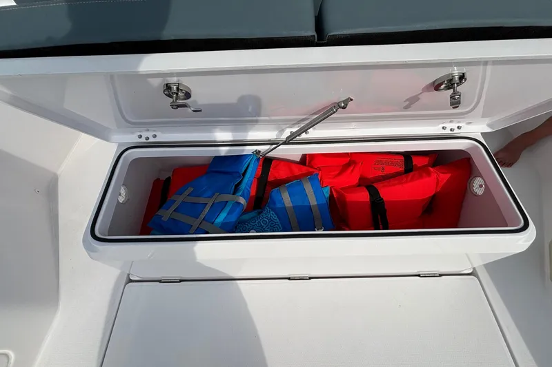 Slide: The Image of Storage compartment on 2022 Axopar 28 Cabin boat with life jackets inside. - 37
