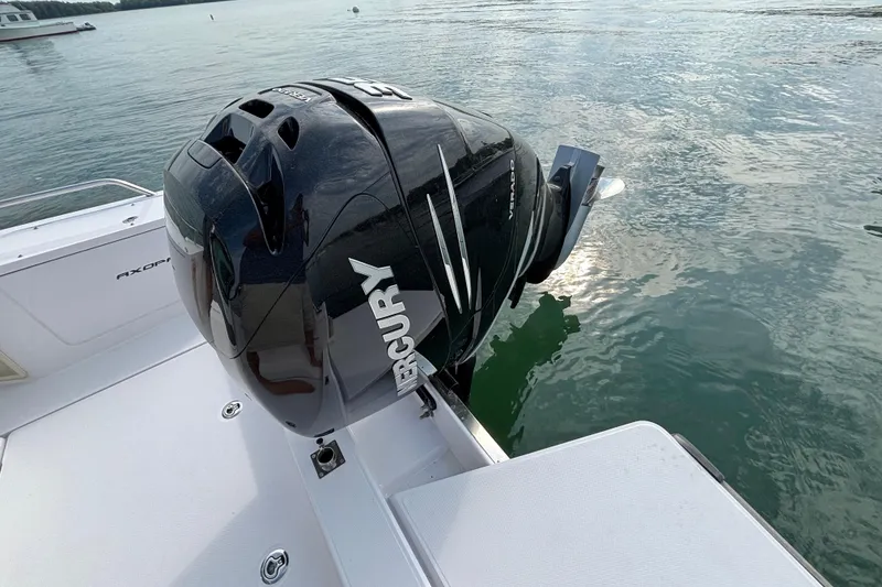 Slide: The Image of 2022 Axopar 28 Cabin with Mercury outboard engine on calm water. - 40