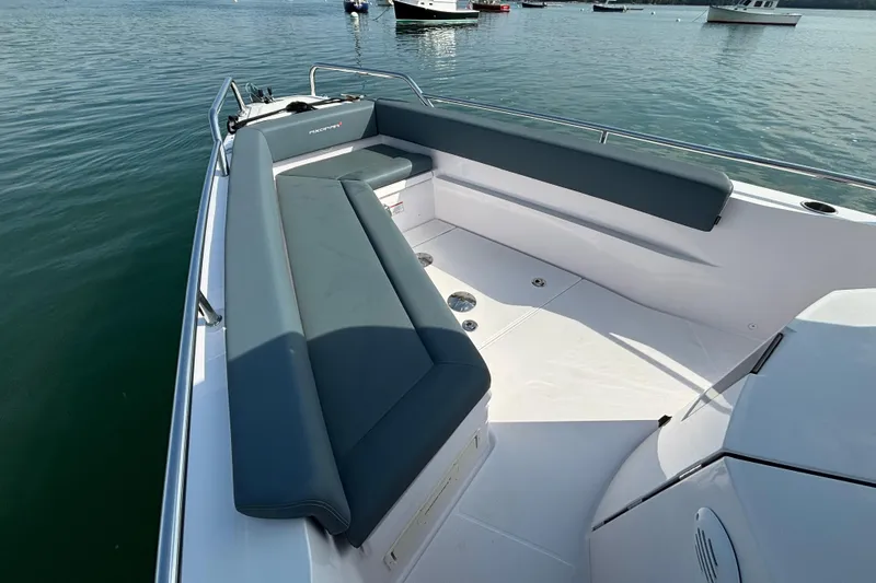 Slide: The Image of 2022 Axopar 28 Cabin boat with spacious seating on calm water. - 9
