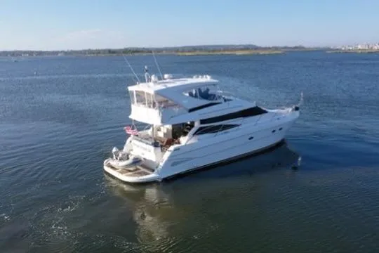 Slide: The Image of 2005 Neptunus 56 Flybridge yacht cruising on calm waters. - 4