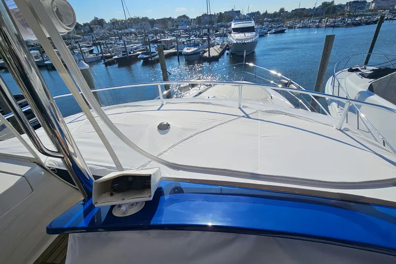 Slide: The Image of 2005 Neptunus 56 Flybridge yacht docked at a marina under sunny skies. - 63