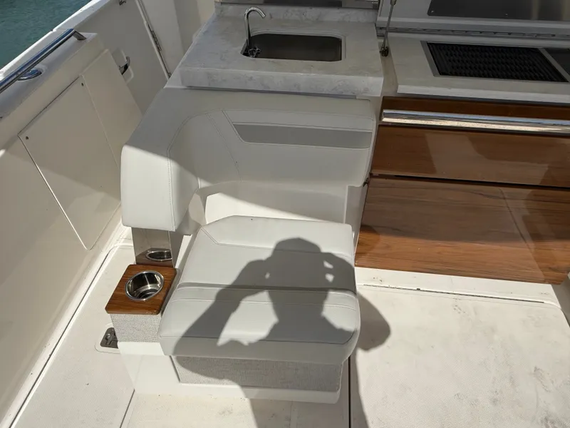 Slide: The Image of Seating area with white upholstery and integrated sink on a Tiara Yachts 38 LS. - 14