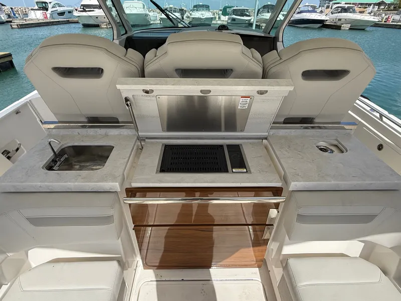 Slide: The Image of 2024 Tiara Yachts 38 LS with sleek outdoor kitchen and luxurious design at the marina. - 15