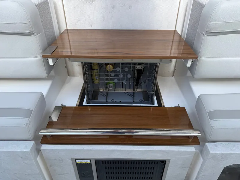 Slide: The Image of A sleek interior with a built-in dishwasher and wooden surfaces on a Tiara Yachts 38 LS. - 16