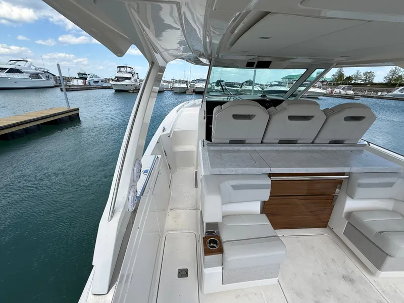 Slide: The Image of 2024 Tiara Yachts 38 LS in a marina, featuring a luxurious seating area and modern design. - 19