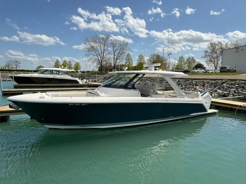 Slide: The Image of 2024 Tiara Yachts 38 LS on the water, featuring a sleek design and spacious deck. - 2