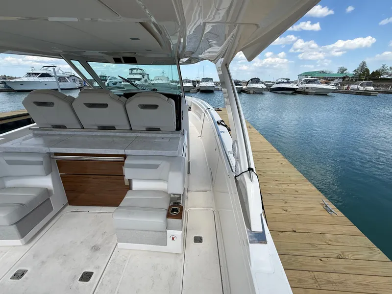 Slide: The Image of Tiara Yachts 38 LS 2024 at dock with luxurious cockpit and seating area. - 20