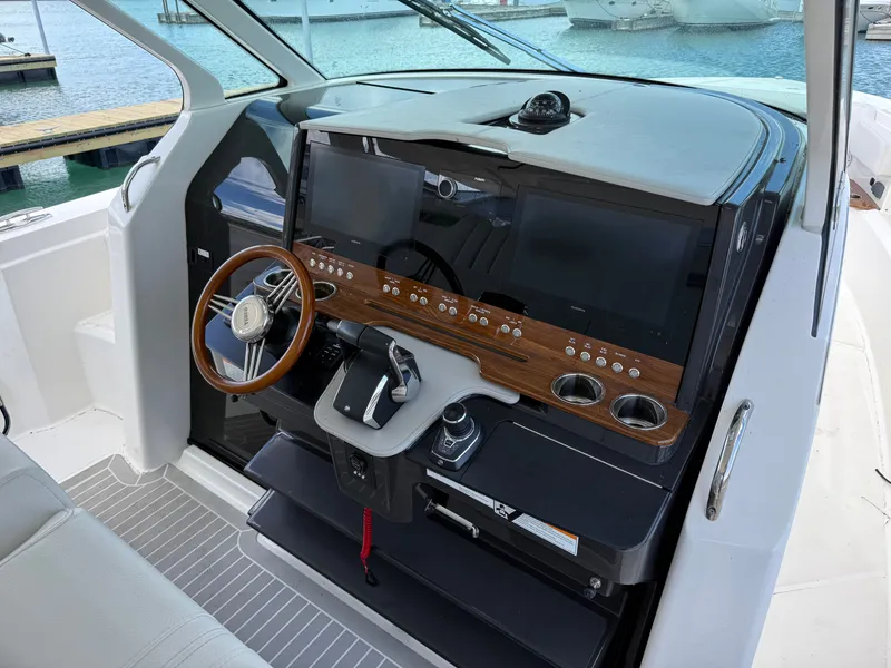 Slide: The Image of Tiara Yachts 38 LS 2024: Luxurious cockpit with modern helm and elegant wood accents. - 21