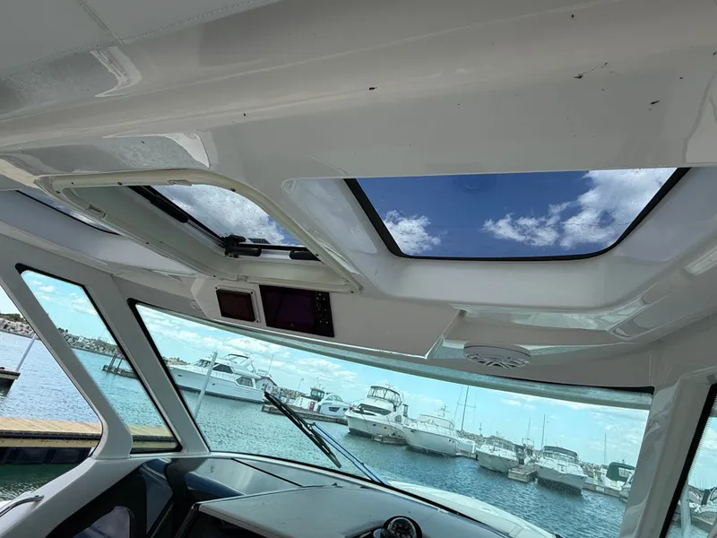 Slide: The Image of Interior view of a Tiara Yachts 38 LS, showing the sky through the sunroof. - 23