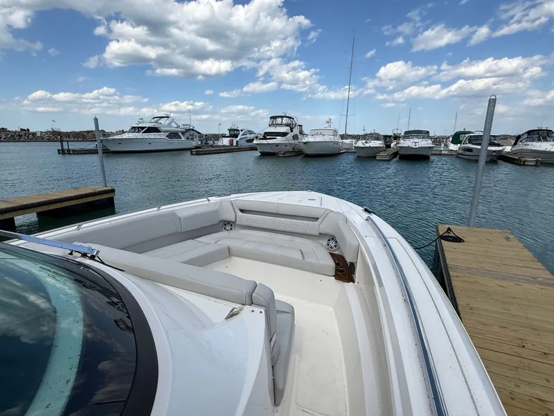 Slide: The Image of 2024 Tiara Yachts 38 LS docked with other boats in the background. - 24