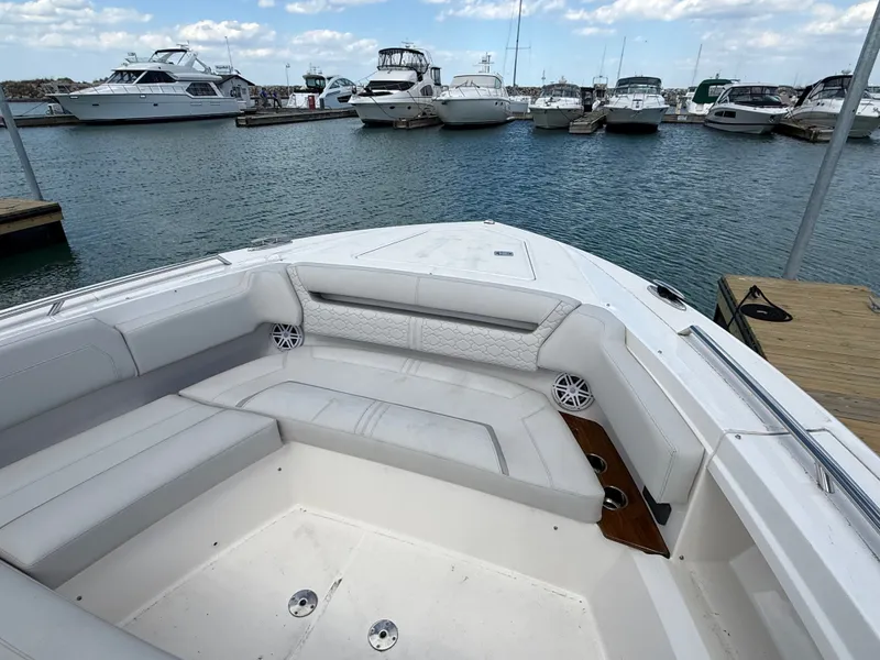 Slide: The Image of 2024 Tiara Yachts 38 LS docked, featuring a luxurious seating area. - 25