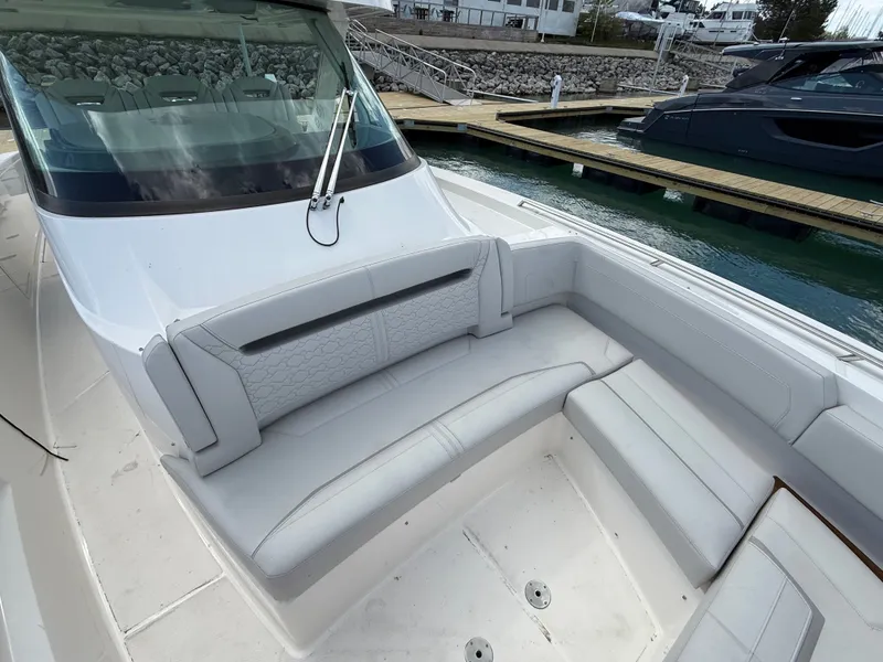 Slide: The Image of 2024 Tiara Yachts 38 LS with sleek white upholstery and spacious seating area at the dock. - 26