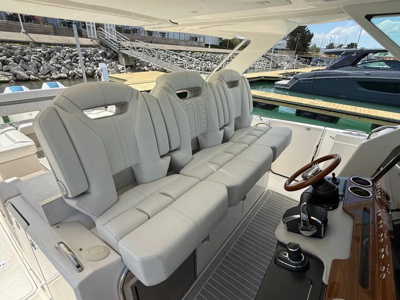 Slide: The Image of Tiara Yachts 38 LS 2024 with luxurious padded seats and modern helm station at the dock. - 31