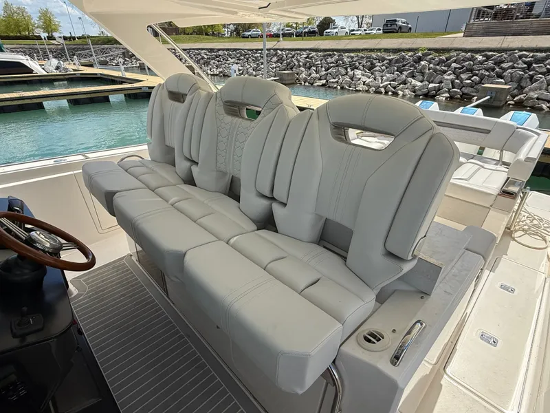Slide: The Image of 2024 Tiara Yachts 38 LS with luxurious, cushioned seating in the cockpit area. - 32
