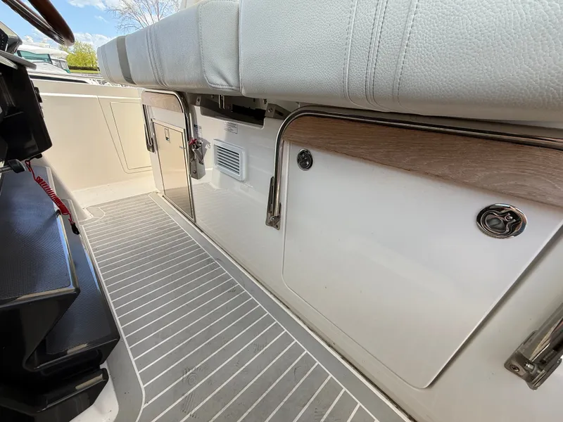 Slide: The Image of Interior of a 2024 Tiara Yachts 38 LS with gray flooring and white upholstery. - 33