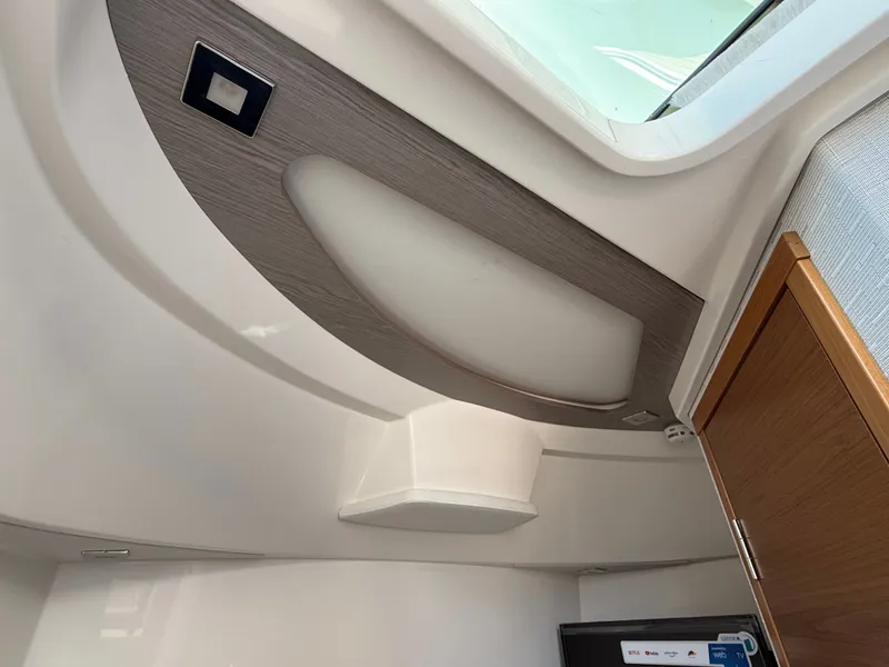 Slide: The Image of Interior of the 2024 Tiara Yachts 38 LS with modern design and wood paneling. - 39