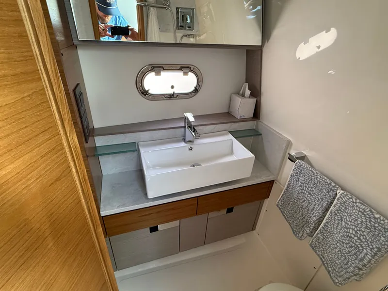 Slide: The Image of The image shows the bathroom of a 2024 Tiara Yachts 38 LS. - 40
