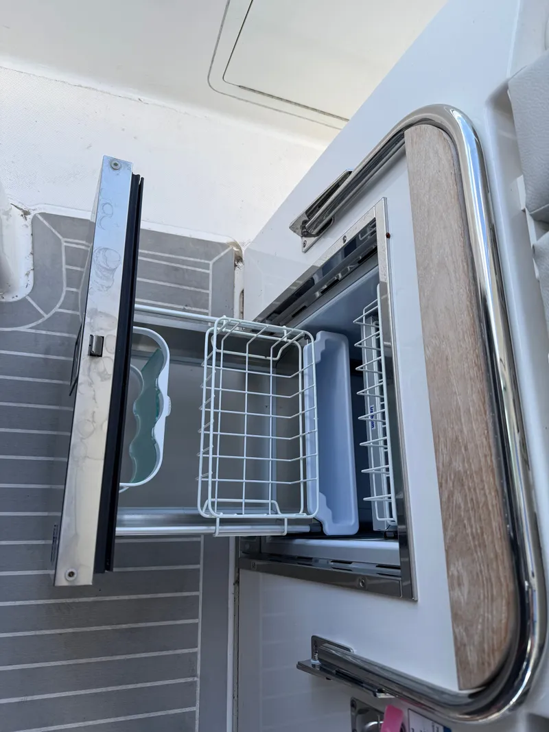 Slide: The Image of An open refrigerator with a pull-out basket and modern design. - 45