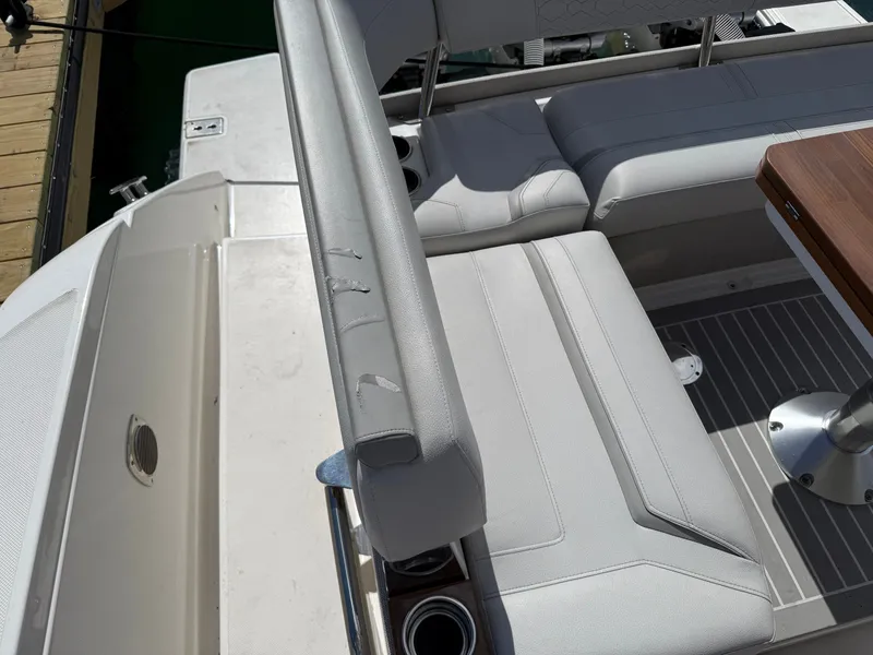 Slide: The Image of The 2024 Tiara Yachts 38 LS features an elegant seating area with white upholstery and a wooden table. - 49