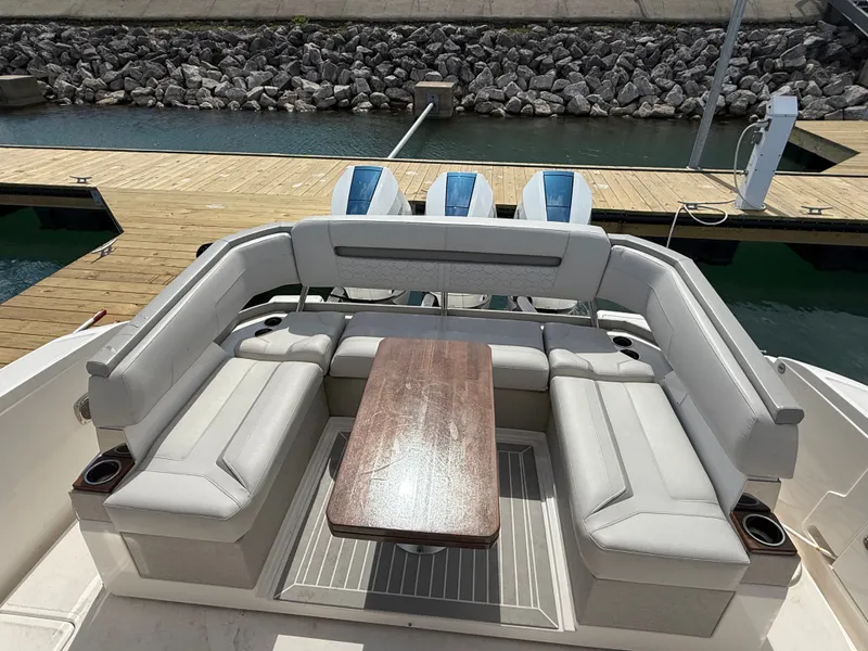 Slide: The Image of The image shows the stern of a 2024 Tiara Yachts 38 LS with a luxurious seating area. - 9