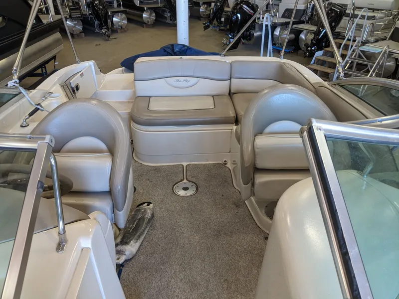 Slide: The Image of Interior view of a Sea Ray 220 Sundeck boat with beige seating and carpeted floor. - 14