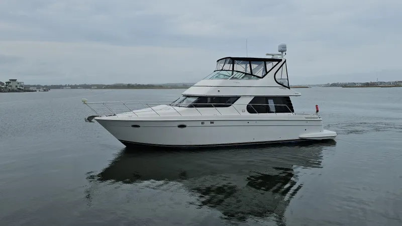 Slide: The Image of 2000 Carver 450 Voyager Pilothouse yacht on calm water, side view. - 5