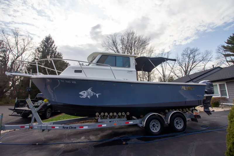 The Image of Parker 2520 XLD Sport Cabin 2022 parked on trailer outdoors. - 0