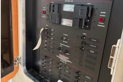 Slide: The Image of Control panel of a 2003 Wellcraft 330 Coastal boat, featuring various switches and indicators. - 6