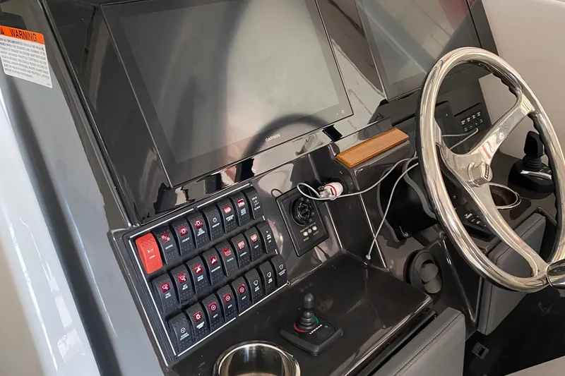 Slide: The Image of 2022 Pursuit DC 365 boat dashboard with dual screens and control panel. - 8