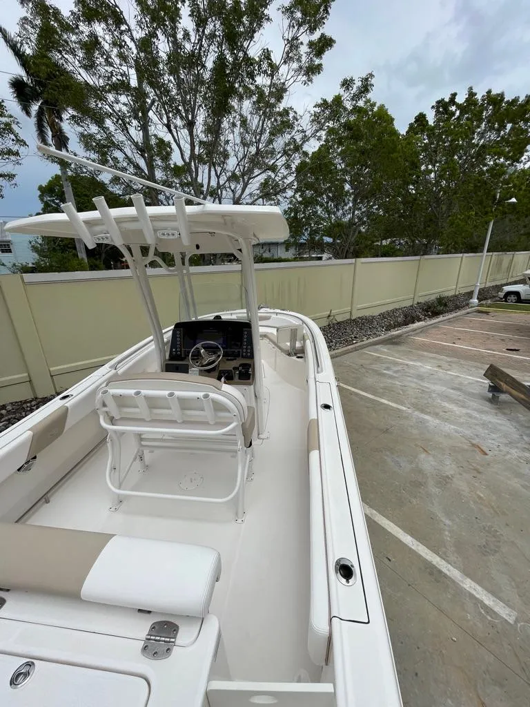 Slide: The Image of 2019 Robalo R242 Center Console boat in a parking lot. - 14