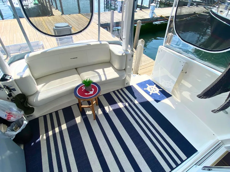 Slide: The Image of 2003 Silverton 39 Motor Yacht with cozy seating area and nautical decor. - 11
