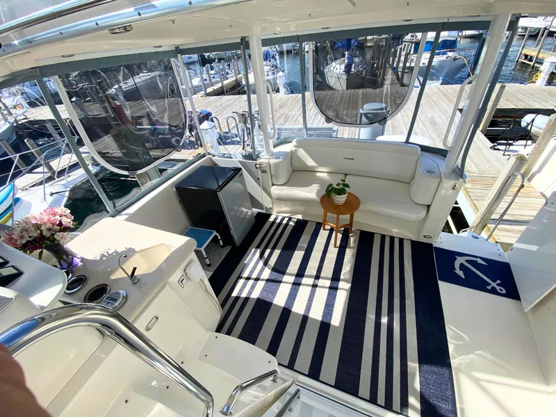 Slide: The Image of Interior of a 2003 Silverton 39 Motor Yacht with seating area and rug. - 13