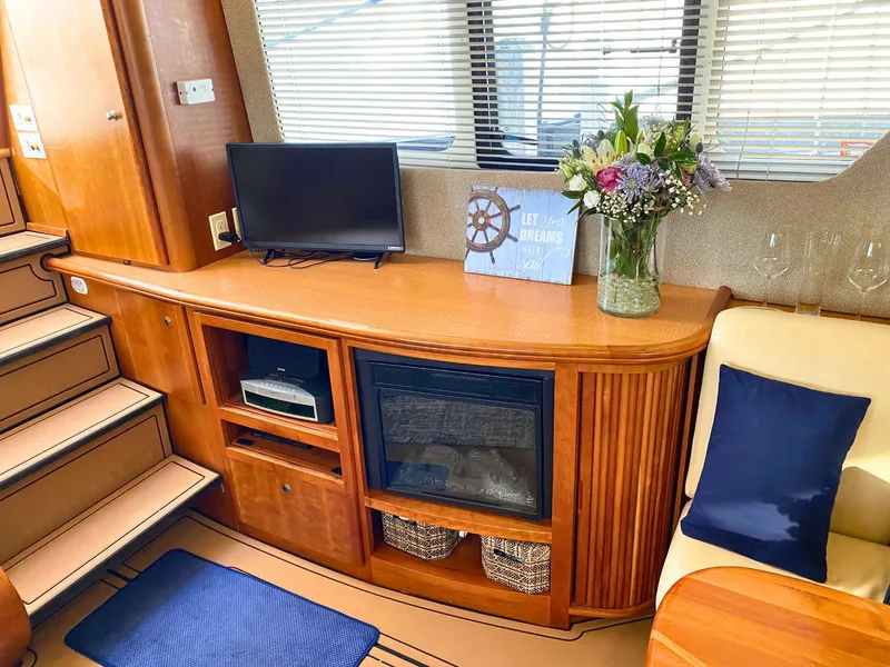 Slide: The Image of Interior of the 2003 Silverton 39 Motor Yacht with TV and fireplace. - 16