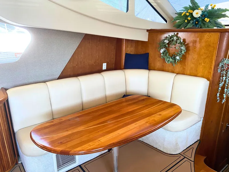 Slide: The Image of Interior of a 2003 Silverton 39 Motor Yacht with elegant seating area and wooden table. - 17