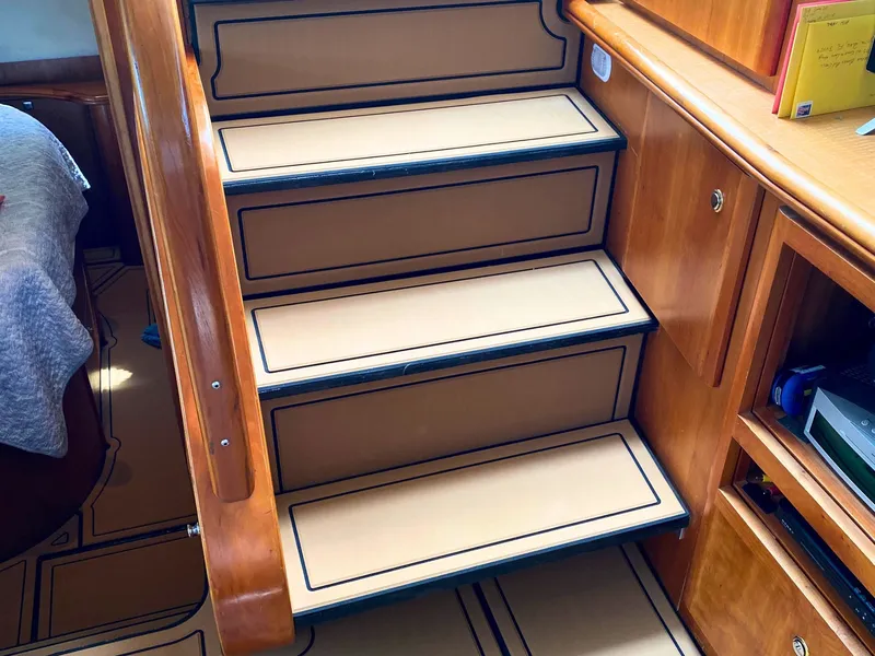 Slide: The Image of Staircase in a 2003 Silverton 39 Motor Yacht with wooden walls and carpeted steps. - 21