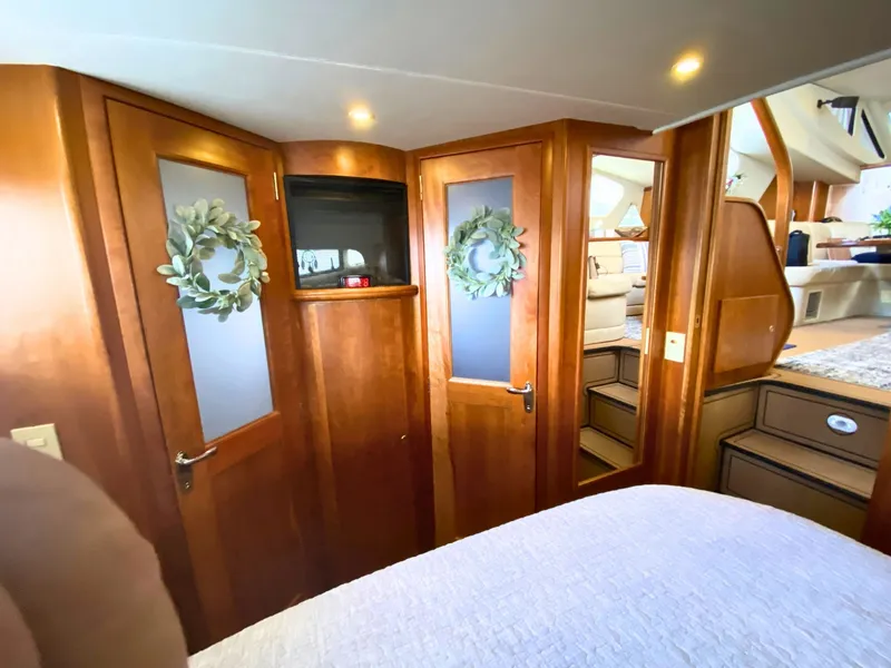 Slide: The Image of Interior of the 2003 Silverton 39 Motor Yacht with wooden doors and cozy furnishings. - 22