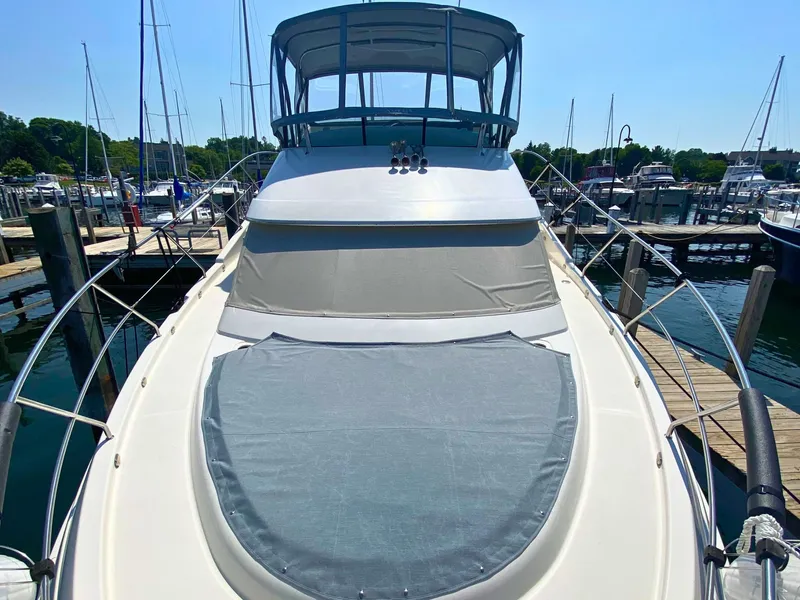 Slide: The Image of 2003 Silverton 39 Motor Yacht docked, featuring a spacious deck and covered helm. - 8
