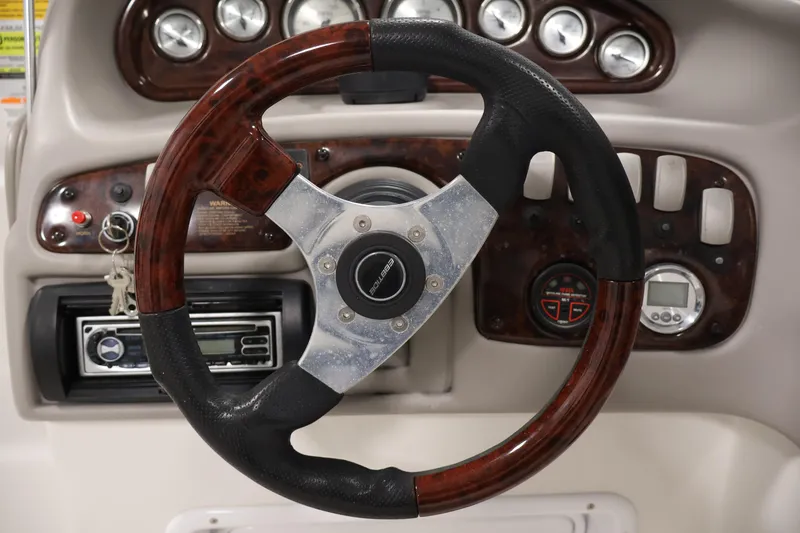 Slide: The Image of Steering wheel and dashboard of 2005 Ebbtide 2300 Sport Cuddy boat. - 16