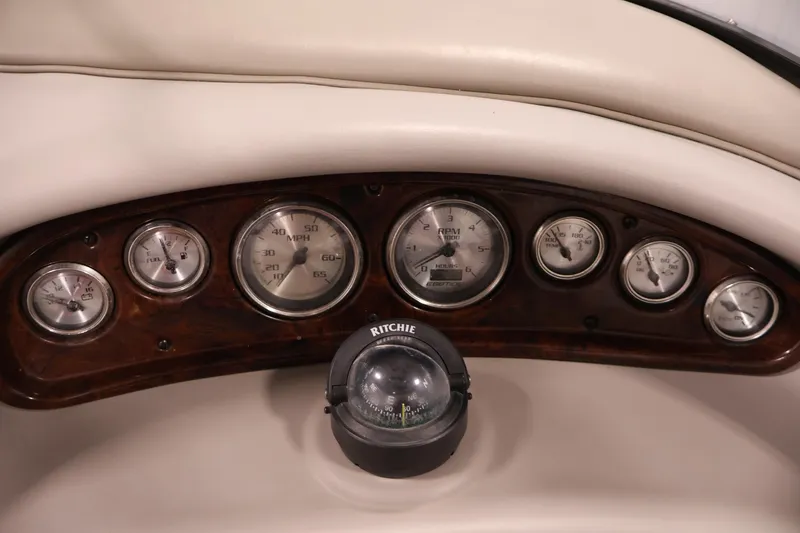 Slide: The Image of Dashboard of 2005 Ebbtide 2300 Sport Cuddy with gauges and compass. - 17