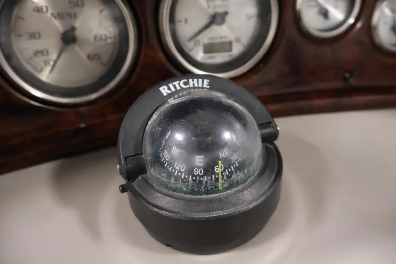 Slide: The Image of Compass and gauges on 2005 Ebbtide 2300 Sport Cuddy dashboard. - 18