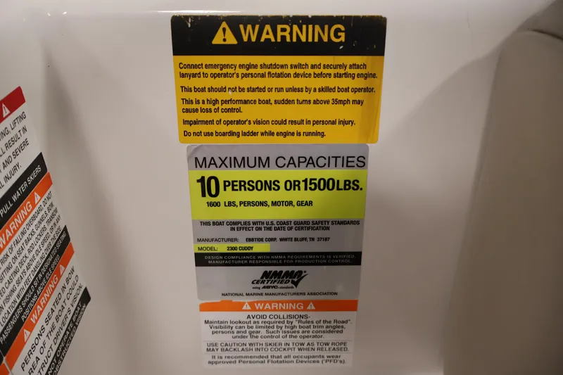 Slide: The Image of Warning label on 2005 Ebbtide 2300 Sport Cuddy, maximum capacity 10 persons or 1500 lbs. - 26