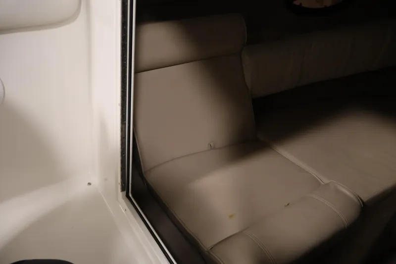 Slide: The Image of 2005 Ebbtide 2300 Sport Cuddy interior with beige seating and cozy cabin space. - 29