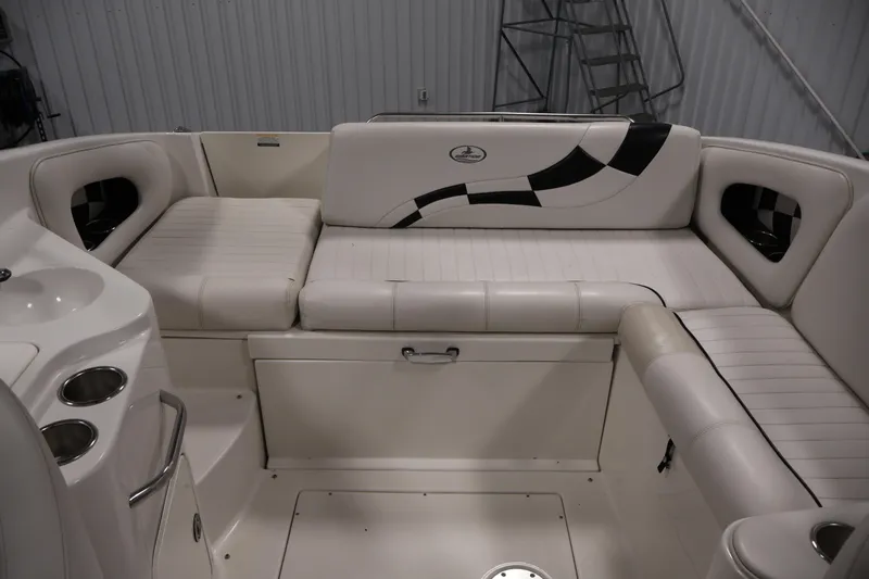 Slide: The Image of 2005 Ebbtide 2300 Sport Cuddy boat interior with white seating and cup holders. - 32