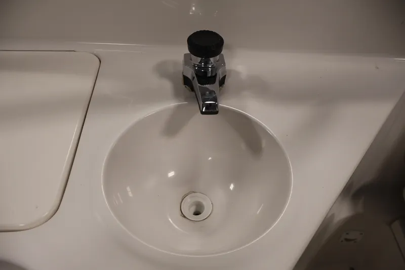 Slide: The Image of 2005 Ebbtide 2300 Sport Cuddy boat sink with chrome faucet. - 36