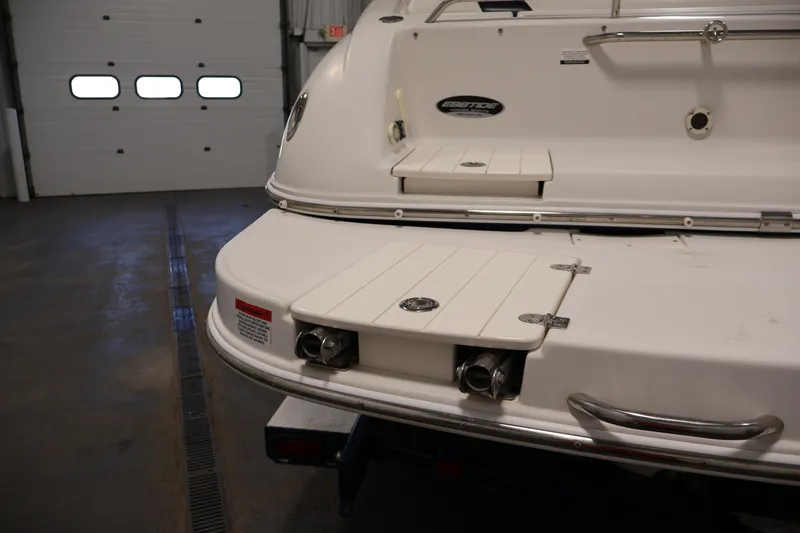 Slide: The Image of 2005 Ebbtide 2300 Sport Cuddy boat stern in a garage setting. - 40