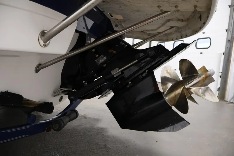 Slide: The Image of 2005 Ebbtide 2300 Sport Cuddy boat propeller and stern detail in a garage setting. - 42