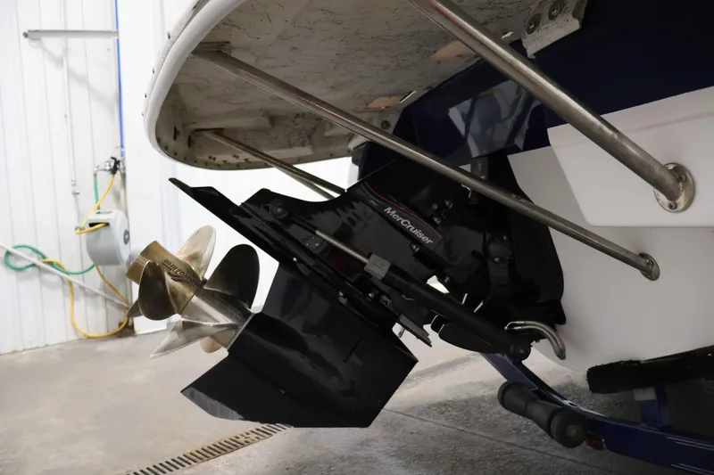 Slide: The Image of 2005 Ebbtide 2300 Sport Cuddy boat with MerCruiser outdrive in a garage. - 43