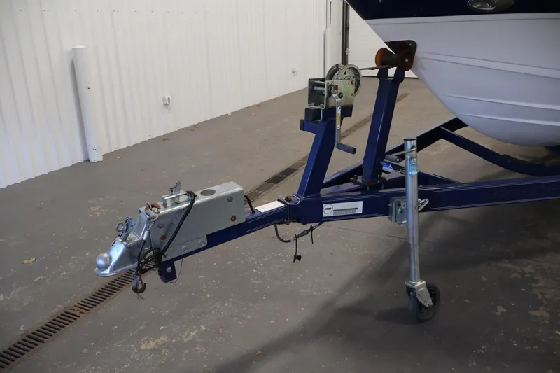Slide: The Image of 2005 Ebbtide 2300 Sport Cuddy boat trailer hitch in a garage setting. - 45